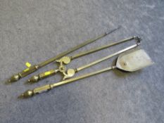 A BRASS THREE PIECE COMPANION SET