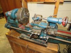 A MYFORD METALWORKING LATHE ON WOODEN PLINTH COMPLETE WITH FOUR JAW CHUCK AND ELECTRIC MOTOR 240V