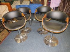 A SET OF FOUR MODERN SWIVEL / ADJUSTABLE KITCHEN STOOLS