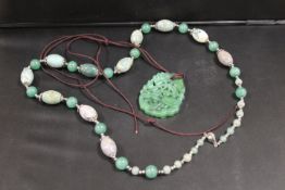 A JADE STYLE PENDANT TOGETHER WITH A POLISHED HARDSTONE NECKLACE