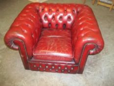 AN OXBLOOD RED LEATHER CHESTERFIELD CHAIR