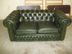 A GREEN LEATHER CHESTERFIELD 2 SEATER SOFA