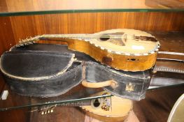 A VINTAGE MANDOLIN WITH TORTOISHELL AND MOTHER OF PEARL INLAY