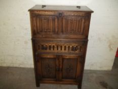 AN OAK PRIORY STYLE DRINKS CABINET