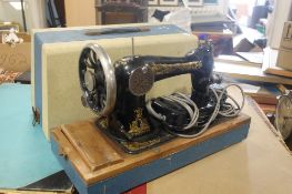 A CASED SINGER SEWING MACHINE