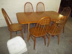 A LIGHT OAK DROPLEAF DINING SET WITH SIX CHAIRS IN THE STYLE OF ERCOL