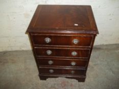 A REPRODUCTION MAHOGANY CHEST OF FOUR DRAWERS