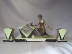 AN ART DECO SPELTER FIGURE CLOCK GARNITURE, with variegated marble and onyx base, showing a female