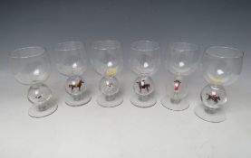 A SET OF SIX STEVENS & WILLIAMS STEMMED NOVELTY WINE GLASSES WITH LAMPWORK EQUESTRIAN SCENES TO