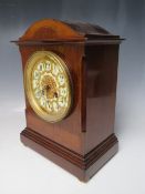A FRENCH MAHOGANY AND INLAID MANTEL CLOCK, the circular dial with Arabic numerals and reticulated