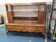 A 19TH CENTURY OAK DRESSER, the open plate rack with two cupboards and five spice drawers, the lower