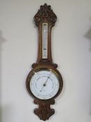 AN EARLY 20TH CENTURY CARVED OAK BAROMETER, by 'Ben Franks Ltd.', H 82 cm