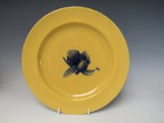 WILLIAM MOORCROFT - A BUTTERSCOTCH GLAZED PLATE WITH MOORCROFT MUSEUM LABEL TO THE BASE, having