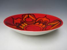 A LARGE POOLE POTTERY DELPHIS PATTERN BOWL, shape 58, decorated in tones of yellow, orange and