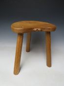 A ROBERT MOUSEMAN THOMPSON THREE LEGGED STOOL, with typical carved mouse to front lip, H 36 cm