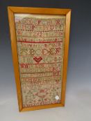 A FRAMED VICTORIAN NEEDLEWORK SAMPLER, dated 1887, framed and glazed, 41 x 19 cm