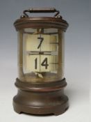 A LATE 19TH / EARLY 20TH CENTURY TICKET CLOCK, the brass case of cylindrical form with two sets