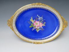 A 20TH CENTURY LIMOGES OVAL PORCELAIN PLATTER, with central floral painted detail on a deep blue