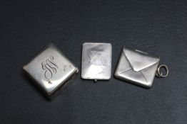 THREE SMALL SILVER BOXES, to include an envelope shaped stamp holder
