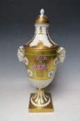 A LARGE DRESDEN GILT TWIN HANDLED VASE AND COVER, with rams head handles and floral painted