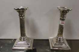 A PAIR OF HALLMARKED SILVER CORINTHIAN COLUMN CANDLESTICKS, Birmingham hallmarks, filled bases, H 21