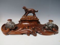 A LATE 19TH / EARLY 20TH CENTURY MAHOGANY DESK TIDY, with pair of inkwells and carved wooden lid