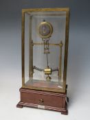 AN EARLY ELECTRIC FOUR GLASS TIMEPIECE, the brass frame supporting a small clock movement and soft