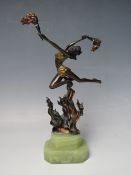 AN ART DECO STYLE BRONZED METAL FIGURE OF A FIRE DANCER, with gilt and copper painted accents to the