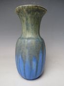 A RUSKIN POTTERY CRYSTALLINE VASE, mottled yellow green drip glaze over blue ground, impressed