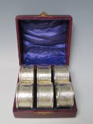 A CASED SET OF SIX EDWARDIAN HALLMARKED SILVER NAPKIN RINGS - BIRMINGHAM 1908, makers mark for J