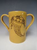 WILLIAM MOORCROFT - A BUTTERSCOTCH GLAZED TWIN HANDLED LOVING CUP WITH MOORCROFT MUSEUM LABEL TO THE