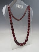 A VINTAGE CHERRY AMBER GRADUATED BEAD NECKLACE, single strand, no fastener, central bead W 2.5 cm,