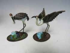 TWO ORIENTAL SILVER AND ENAMEL FIGURES OF CRANES, both marked 'SILVER' to the underside, tallest H