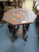AN EASTERN CARVED TWO TIER OCCASIONAL TABLE