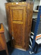 A 19TH CENTURY OAK INLAID CORNER CUPBOARD