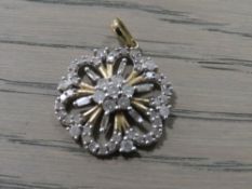 A LADIES 10CT DIAMOND SET FLORAL PENDANT