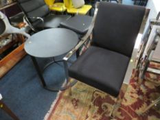A MODERN BLACK AND CHROMED ARMCHAIR WITH BLACK METAL TABLE (2)