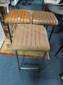 THREE MODERN TAN LEATHER STOOLS