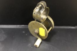 A SMALL VINTAGE BRASS FISHING REEL