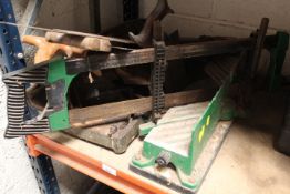 A CAST IRON MITRE GUILLOTINE WITH MITRE SAW AND VARIOUS WOOD SAWS