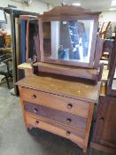 A VINTAGE THREE DRAWER DRESSING TABLE