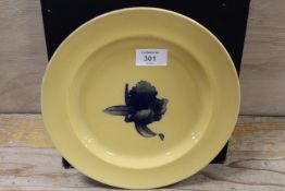 WILLIAM MOORCROFT - A BUTTERSCOTCH GLAZED PLATE WITH MOORCROFT MUSEUM LABEL TO THE BASE, having