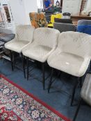 A SET OF THREE MODERN TAUPE UPHOLSTERED KITCHEN STOOLS