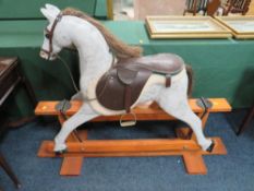 AN EARLY 20TH CENTURY 'NORMAN WOOD' ROCKING HORSE ON PINE TRESTLE BASE, bearing label to neck,