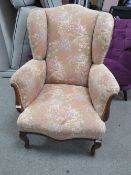 AN UPHOLSTERED ARMCHAIR