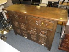 A VINTAGE CARVED OAK SIDEBOARD