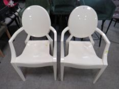 A PAIR OF MODERN 'GHOST' STYLE PLASTIC ARMCHAIRS