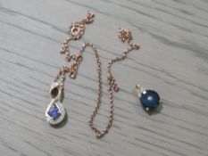 A 10K SMALL CIRCULAR GEM SET PENDANT TOGETHER WITH ANOTHER PENDANT ON ROSE GOLD CHAIN (2)