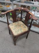 AN ANTIQUE CORNER ARMCHAIR