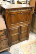 AN OAK LINENFOLD DRINKS CABINET W 80 CM